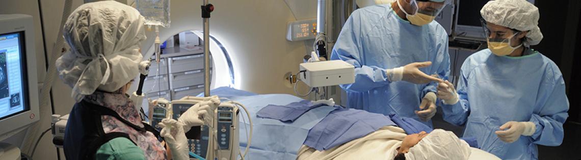 Doctors at the Clinical Center prepare to begin interventional radiology on a patient.