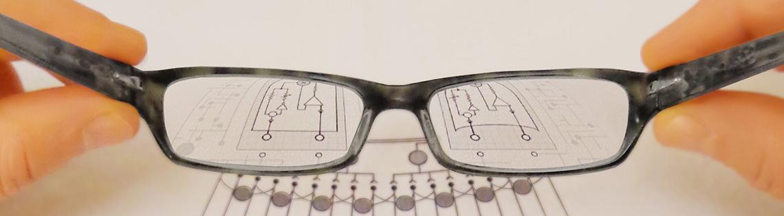 Image of eyeglasses magnifying a diagram.