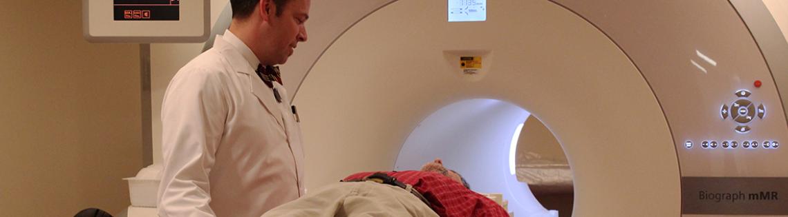 Technologist talks to patient in a scanner.