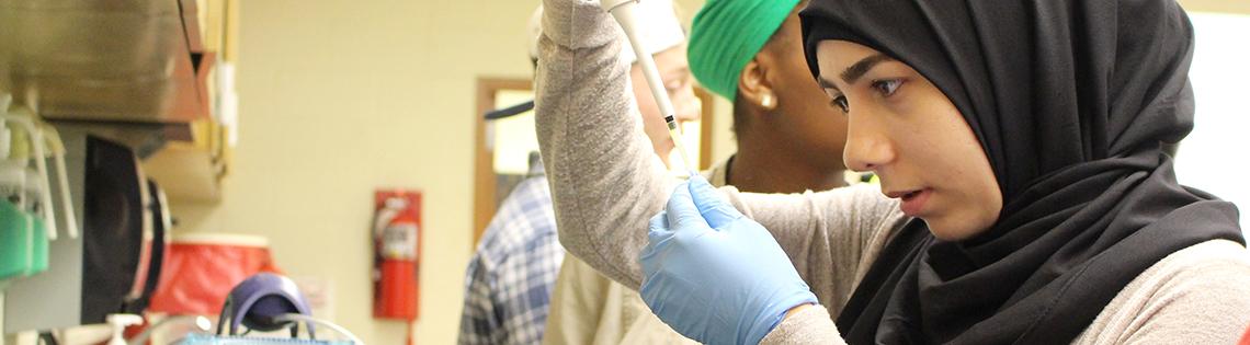 Alhabib practices pipetting in a lab
