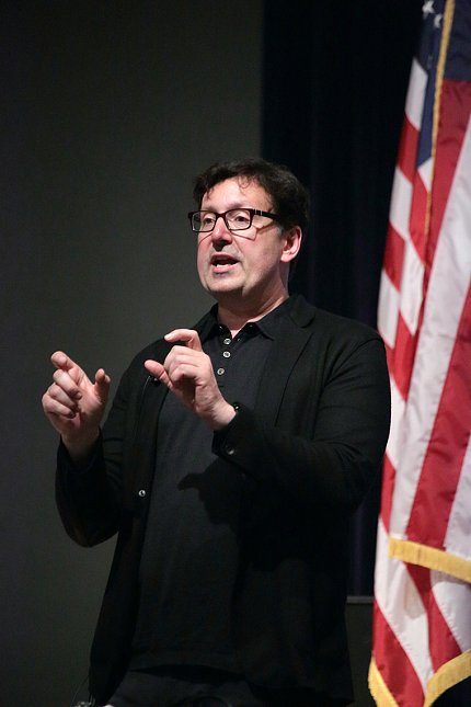 Scientist speaks at podium.