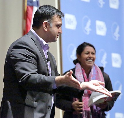 Parashar speaks as a woman looks on