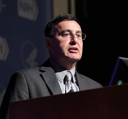 Dr. Zarate speaks at podium.