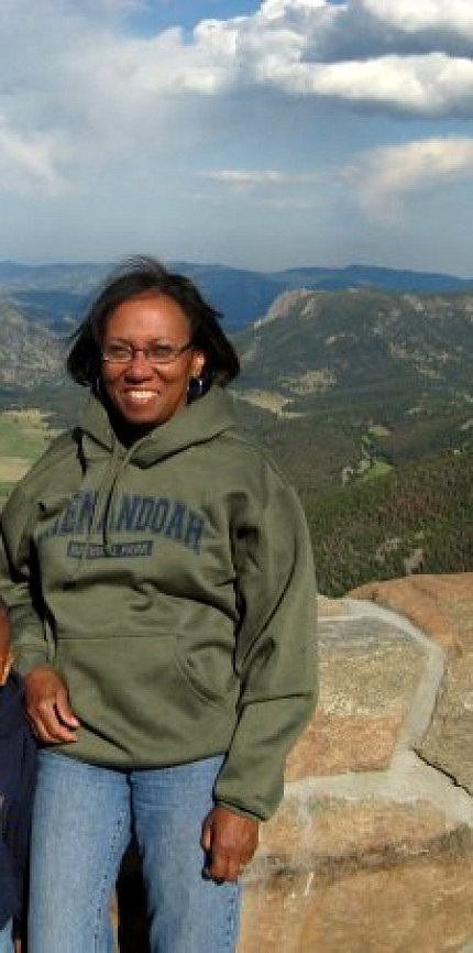 London, with scenic landscape behind her