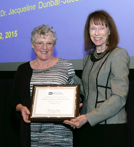 Dunbar-Jacob and Grady hold plaque