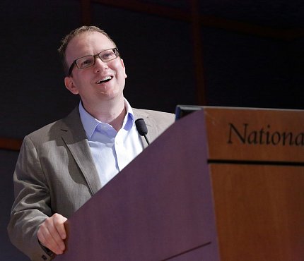 Greene speaks at podium