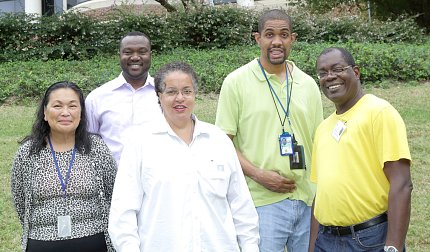 Five people smile for the camera.