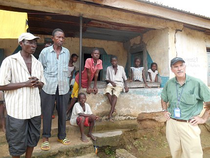 Kilmarx and several residents stand in front of home
