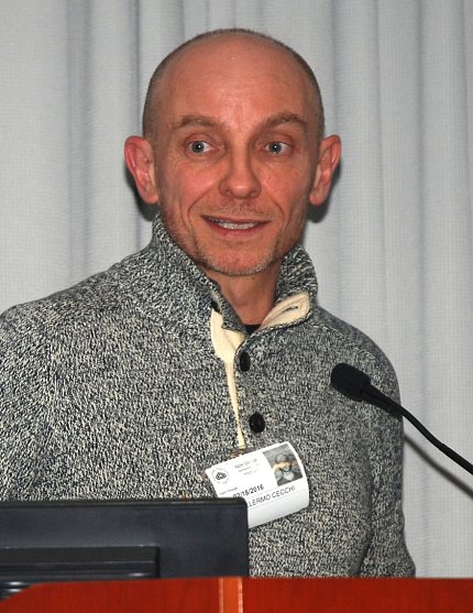 Cecchi smiles, speaking at podium