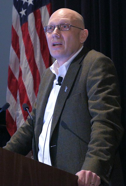 Rosenstein stands at podium