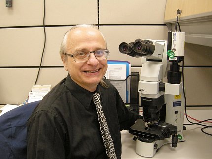 Brosky sit next a microscope