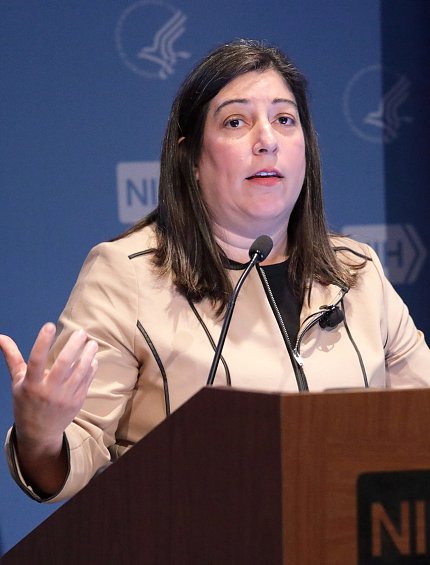 Houry at the podium at NIH