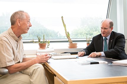  Youle talks with Coons across a desk