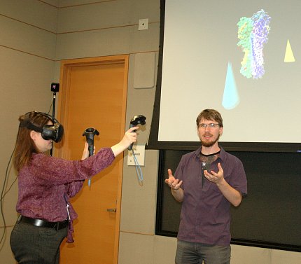 Scientist wears virtual reality goggles.
