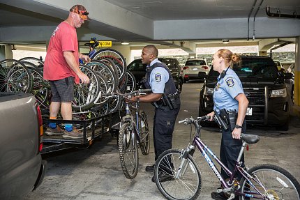 Officers load bikes onto truck.