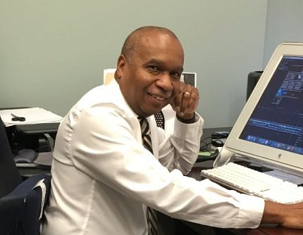 Jackson sits at his desk