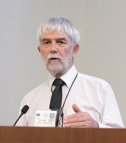 Murray-Rust speaks at a podium