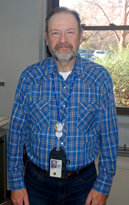 Putnam stands in front of a window