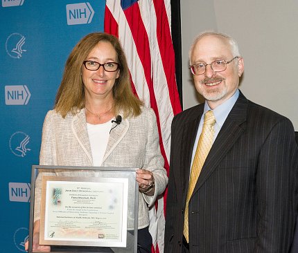 Dr. Marshall holds plaque given by Dr. Jacobson.