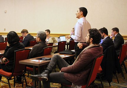 One researcher stands while others look on