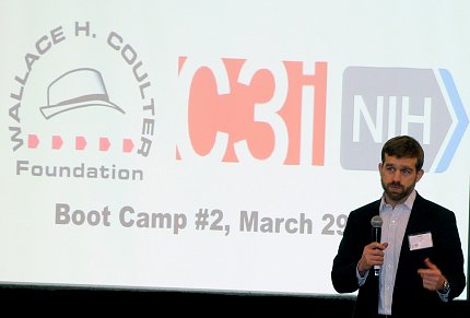 Merchak speaks in front of an audience