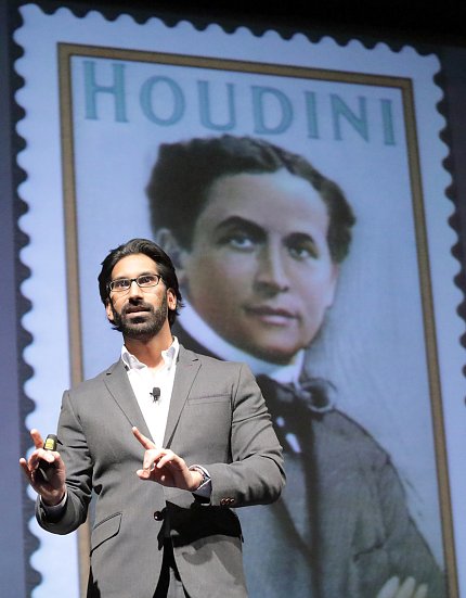 Pittampalli stands in front of a slide featuring a stamp of Houdini
