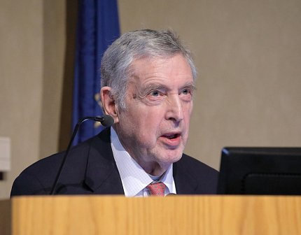 Dr. Noon speaks at podium.