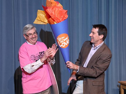 Koroshetz passes this year’s CFC Olympic torch to Dr. Christopher Austin.