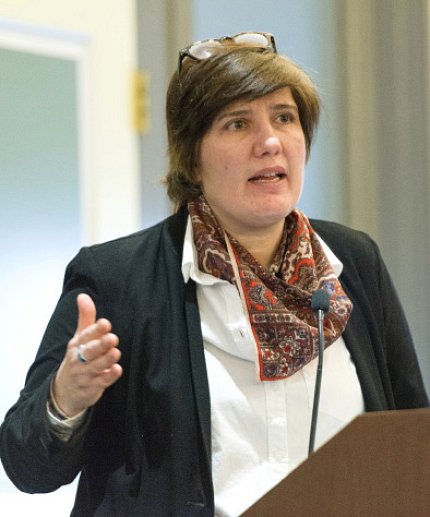 Dr. Nihal Altan-Bonnet speaks at the podium.