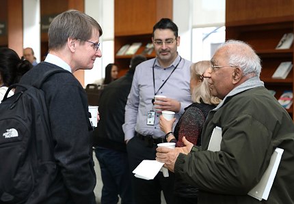Dr. Pamer chats with lecture attendees at reception