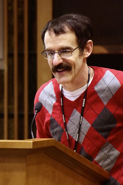 Resnik speaks at a podium 