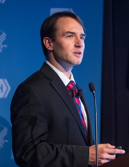 Dr. Andrew Demidowich lectures at an NIH podium
