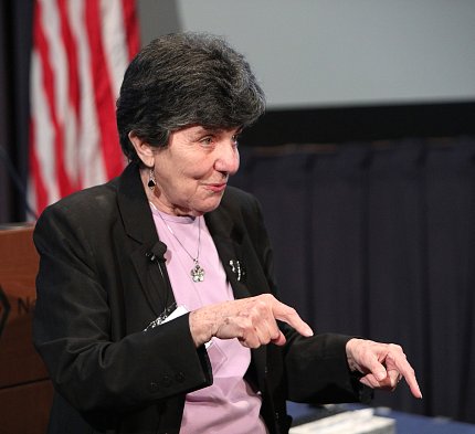 DeAngelis speaking and pointing downward with both hands.