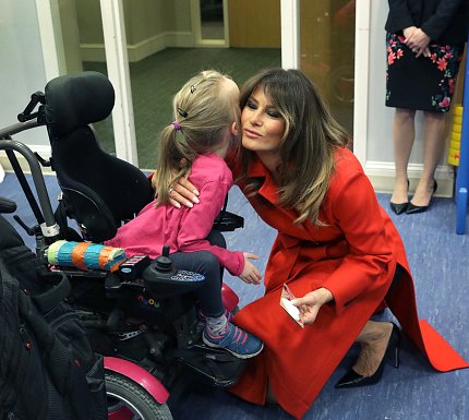 The first lady embraces Alexis “Lexi” Bingham.