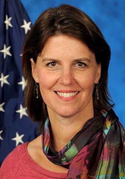 head shot of Dr. Tracy Gaudet in front of American flag