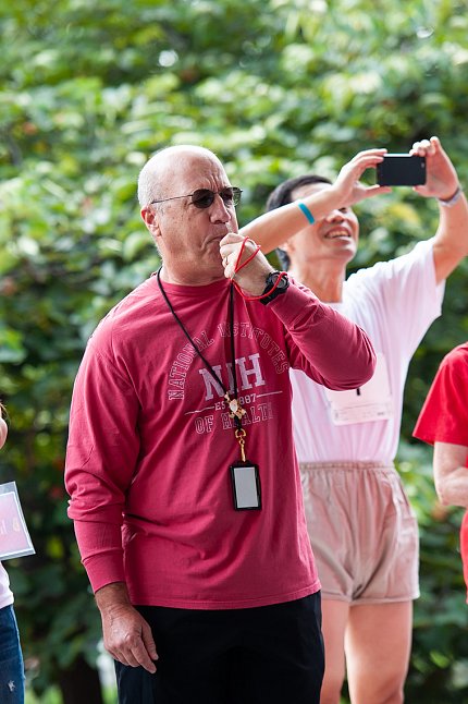 Dr. James Gilman blows a whistle to start the race.