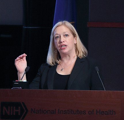 Dr. Schneider presents at a podium