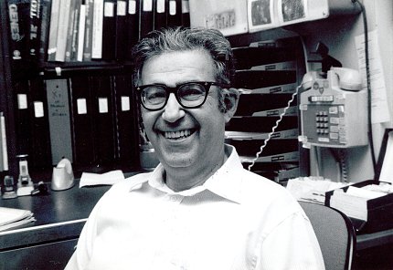 Dr. Rosen smiles in his office