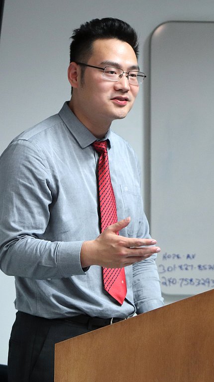 Dr. Jiang speaks at a podium