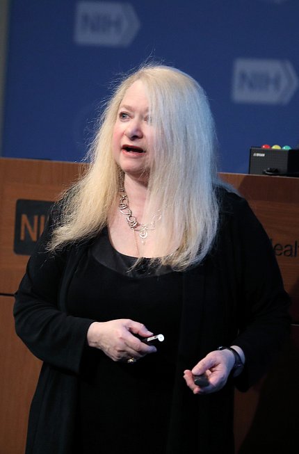 Dr. Berman stands in front of podium