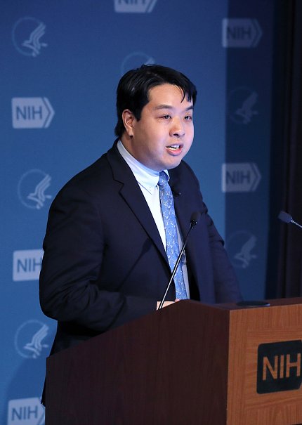 Dr. Chiu stands behind a podium