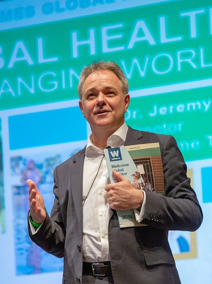 Farrar holds a copy of the first Wellcome Global Monitor report.