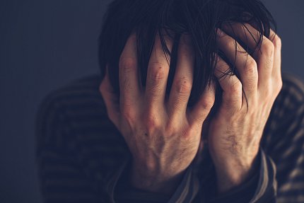 A man holding his head