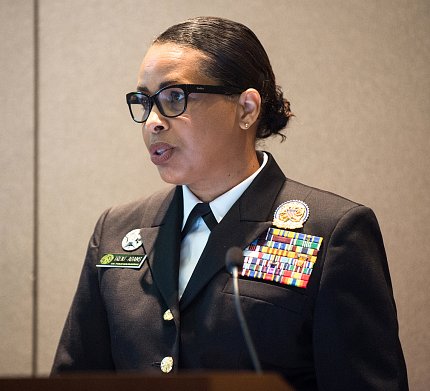 Woman in Commissioned Corps uniform speaks at podium.