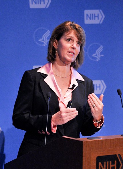 Gaudet looks up from a podium