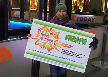 Anderson holds an NDAFW sign outside NBC’s The Today Show studio in New York