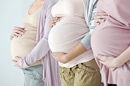 Photo of the bellies of three pregnant women