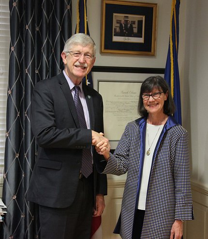 NIH director Dr. Francis Collins shakes hands with new NCCIH director Dr. Helen Langevin