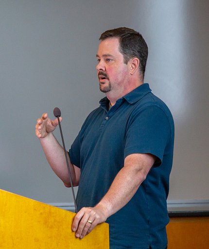 Conlan speaks at podium