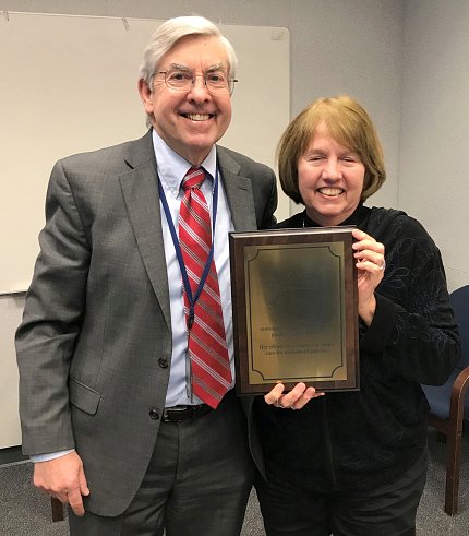 Koroshetz presents Hart with a plaque